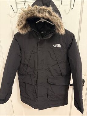 The North Face boy’s Black Hooded Puffer Parka with Faux Fur Trim